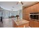 Bright kitchen featuring a large island, stainless appliances, and an adjacent dining area with pool views at 7108 229Th E St, Bradenton, FL 34211