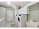 Well-equipped laundry room featuring modern appliances, ample storage, and a utility sink at 7108 229Th E St, Bradenton, FL 34211