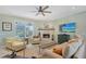 Bright living room with a fireplace, neutral tones, and a view of the pool at 7108 229Th E St, Bradenton, FL 34211