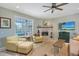 Cozy living room with fireplace, comfortable seating, and views of the pool at 7108 229Th E St, Bradenton, FL 34211