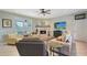 Cozy living room featuring a stone fireplace, comfortable seating, and a view of the backyard at 7108 229Th E St, Bradenton, FL 34211