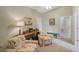 Inviting living room with a ceiling fan, complemented by floral seating and soft natural light at 7108 229Th E St, Bradenton, FL 34211