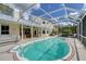 Lovely caged pool with spa, and an outdoor bar and seating area at 7108 229Th E St, Bradenton, FL 34211