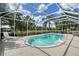 Enclosed pool area with brick-lined pool, lounge chair, landscaping and a serene outdoor view at 7108 229Th E St, Bradenton, FL 34211