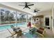 Covered pool patio area with comfortable seating and a tropical bar at 7108 229Th E St, Bradenton, FL 34211