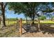 Outdoor horse wash rack featuring wooden posts, concrete pad, and green hose at 7108 229Th E St, Bradenton, FL 34211