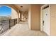 Neutral-painted hallway with a view of the lake and trees showcasing tile flooring and unit doors at 7612 Lake Vista Ct # 406, Lakewood Ranch, FL 34202