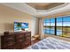 Brightly-lit main bedroom with a ceiling fan and views of the outside landscape at 7612 Lake Vista Ct # 406, Lakewood Ranch, FL 34202