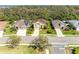 Overhead capture of a landscaped home featuring a verdant treeline, complemented by clear skies at 8124 115Th E Ave, Parrish, FL 34219