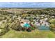 Beautiful aerial view of community clubhouse, pool, and basketball court, surrounded by lush landscaping and neighborhood homes at 8124 115Th E Ave, Parrish, FL 34219