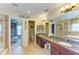 Bathroom with dual sinks, granite countertops, walk-in shower, separate soaking tub and walk-in closet at 8124 115Th E Ave, Parrish, FL 34219