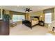 Bedroom featuring a ceiling fan, a large window for natural light, and carpet flooring at 8124 115Th E Ave, Parrish, FL 34219