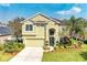 Charming two-story home featuring a well-manicured lawn and vibrant landscaping under a sunny sky at 8124 115Th E Ave, Parrish, FL 34219