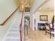 Welcoming foyer with staircase, tiled flooring, and tasteful decor at 8124 115Th E Ave, Parrish, FL 34219