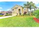Beautiful home with lush green lawn, attractive landscaping, and mature trees under a bright sky at 8124 115Th E Ave, Parrish, FL 34219