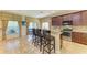 Kitchen featuring an island, bar stool seating, stainless steel appliances, and lots of natural light at 8124 115Th E Ave, Parrish, FL 34219