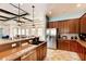 Community kitchen featuring granite countertops, stainless steel appliances, tile flooring, and warm wood cabinetry at 8124 115Th E Ave, Parrish, FL 34219