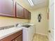 Functional laundry room with modern appliances, a utility sink, and plenty of cabinet space at 8124 115Th E Ave, Parrish, FL 34219