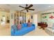 Cozy living room with ceiling fan, built-in bookcase, and comfortable blue sofa at 8124 115Th E Ave, Parrish, FL 34219