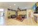 Spacious living area with a fireplace, ceiling fan, and comfortable seating at 8124 115Th E Ave, Parrish, FL 34219