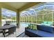 Outdoor patio featuring a dining set, comfortable couch and view of the pool area at 8124 115Th E Ave, Parrish, FL 34219