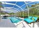 Resort-style screened pool with sun loungers and meticulous landscaping at 8124 115Th E Ave, Parrish, FL 34219