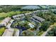 Scenic aerial view of community featuring a pool, golf course, tennis courts, and pristine landscaping at 8951 Veranda Way # 621, Sarasota, FL 34238
