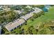 Aerial view of condo buildings surrounded by golf course and lakes at 8951 Veranda Way # 621, Sarasota, FL 34238