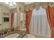 Charming bathroom with granite countertop, decorative curtains, and traditional fixtures at 8951 Veranda Way # 621, Sarasota, FL 34238