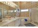 Bright bathroom featuring a soaking tub, shower, and dual vanity at 8951 Veranda Way # 621, Sarasota, FL 34238