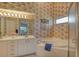 Bright bathroom featuring a soaking tub, white cabinetry, and large mirror at 8951 Veranda Way # 621, Sarasota, FL 34238