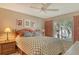 Comfortable bedroom with natural light, ceiling fan and matching nightstands at 8951 Veranda Way # 621, Sarasota, FL 34238