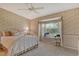 Cozy bedroom with floral wallpaper, carpet and a bay window offering natural light and charm at 8951 Veranda Way # 621, Sarasota, FL 34238