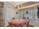 Bright breakfast nook with chandelier, bay window and stainless steel refrigerator and access to the kitchen at 8951 Veranda Way # 621, Sarasota, FL 34238