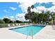 Refreshing community pool with lounge chairs and clear blue water under a sunny sky at 8951 Veranda Way # 621, Sarasota, FL 34238