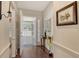Inviting foyer features beautiful hardwood floors, decorative accents, and seamless access to the screened porch at 8951 Veranda Way # 621, Sarasota, FL 34238