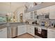 Updated kitchen featuring white cabinetry, stainless steel appliances and granite countertops overlooking eat-in kitchen at 8951 Veranda Way # 621, Sarasota, FL 34238