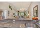 Open floorplan with granite countertops, stainless steel sink, and a view to the dining room, creating a seamless flow at 8951 Veranda Way # 621, Sarasota, FL 34238