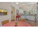 Bright kitchen featuring stainless steel appliances, wood floors, and an adjacent breakfast nook with chandelier at 8951 Veranda Way # 621, Sarasota, FL 34238