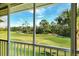 Expansive view of the lush green golf course from the screened-in lanai at 8951 Veranda Way # 621, Sarasota, FL 34238