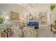 Inviting living room with vaulted ceiling, neutral carpet, comfortable seating and view into the eat-in kitchen at 8951 Veranda Way # 621, Sarasota, FL 34238