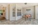 Charming tiled patio area with a cozy seating arrangement and ample natural light at 8951 Veranda Way # 621, Sarasota, FL 34238