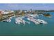 Expansive aerial view showcases a yacht club and luxury boats in a scenic harbor setting at 100 Central Ave # C521, Sarasota, FL 34236