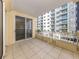 Large outdoor balcony featuring tile flooring, a building view, and a railing at 100 Central Ave # C521, Sarasota, FL 34236