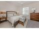 Bright bedroom featuring a queen bed, neutral decor, and a window with blinds at 100 Central Ave # C521, Sarasota, FL 34236