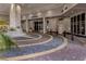 Elegant entryway featuring pavers, stone accents, and manicured greenery leading to 100 Central at 100 Central Ave # C521, Sarasota, FL 34236