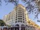 Stunning condo building with multiple balconies, street-level retail, and lush palm trees at 100 Central Ave # C521, Sarasota, FL 34236
