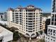 Beautiful multi-story condo building featuring balconies and a terracotta roof in a vibrant urban neighborhood at 100 Central Ave # C521, Sarasota, FL 34236