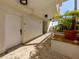 Well-maintained hallway featuring a brick path and beautifully curated potted plants at 100 Central Ave # C521, Sarasota, FL 34236