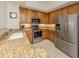 Well-lit kitchen featuring stainless steel appliances, granite countertops, and tile flooring at 100 Central Ave # C521, Sarasota, FL 34236